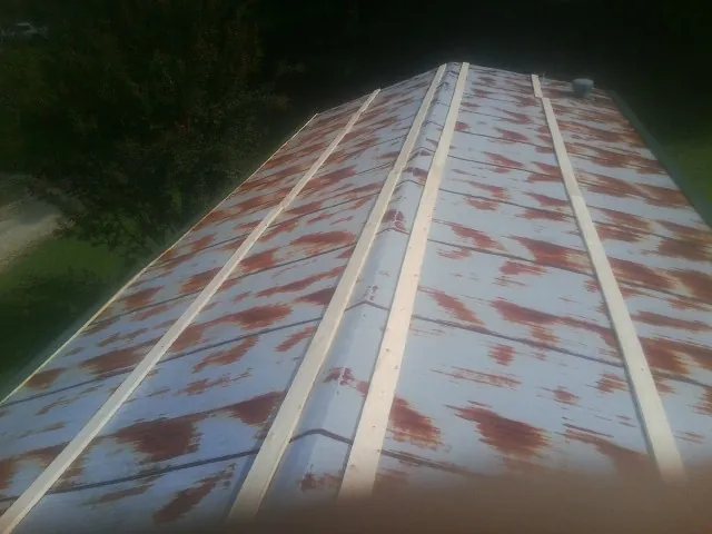Rusted metal roof panels with new wood purlins before replacement — Storm Damage Roof Repair in Oriskany Falls by Roofing Brothers